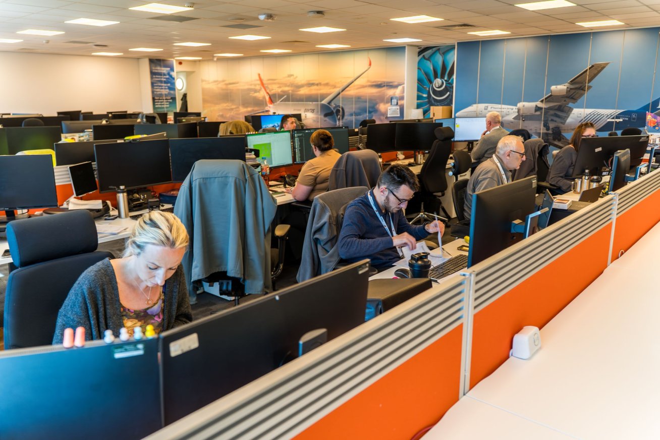 Open plan office with aviation murals on the walls