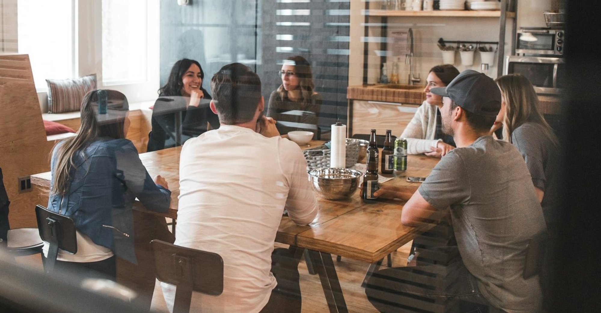 Colleagues talking around a table in a kitchen